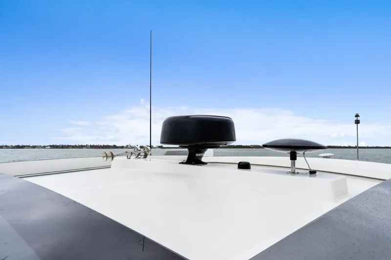 Slide: The Image of Riviera 5400 Sport Yacht 2021 rooftop with radar, antenna, and clear blue sky. - 34