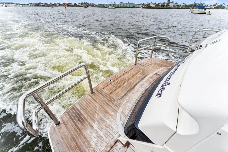 Slide: The Image of Riviera 5400 Sport Yacht 2021 cruising on open water, rear deck view. - 35