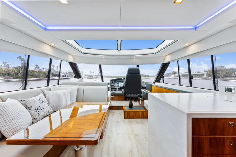 Slide: The Image of Luxurious interior of 2021 Riviera 5400 Sport Yacht with panoramic windows and modern furnishings. - 41