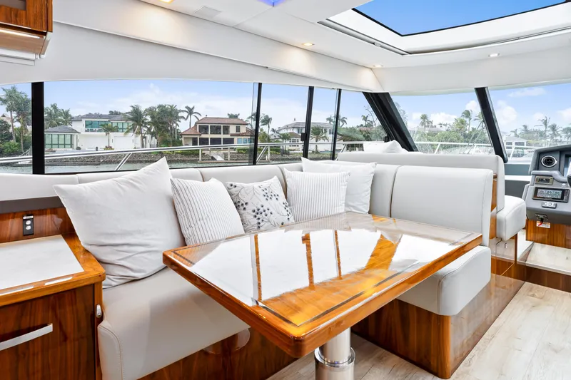 Slide: The Image of Luxurious interior of 2021 Riviera 5400 Sport Yacht with plush seating and elegant wood table. - 42