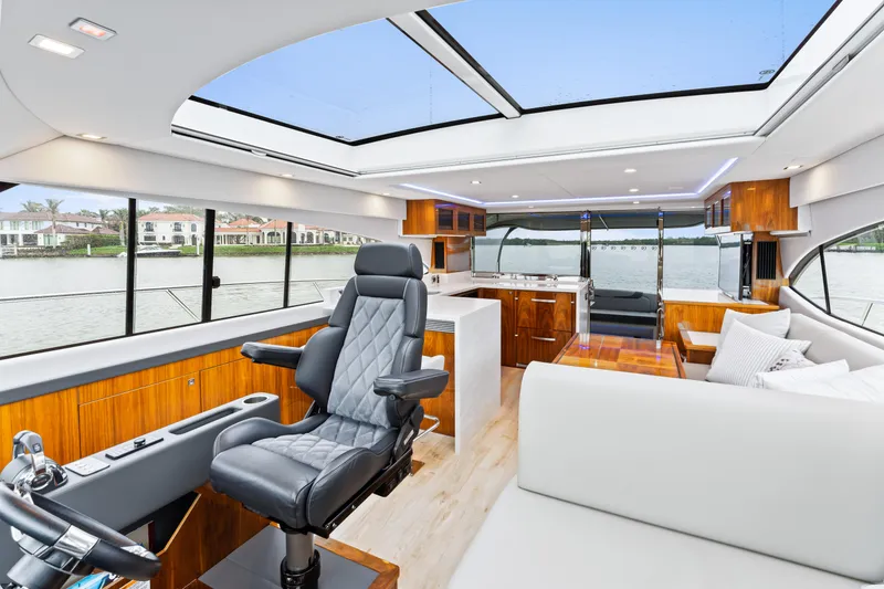 Slide: The Image of Luxurious interior of 2021 Riviera 5400 Sport Yacht with panoramic windows and modern furnishings. - 45