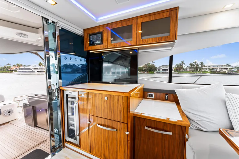 Slide: The Image of Luxurious interior of 2021 Riviera 5400 Sport Yacht with modern wood cabinetry and scenic view. - 49