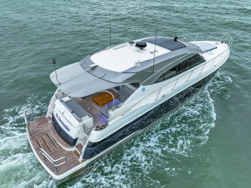 Slide: The Image of 2021 Riviera 5400 Sport Yacht cruising on open water. - 6