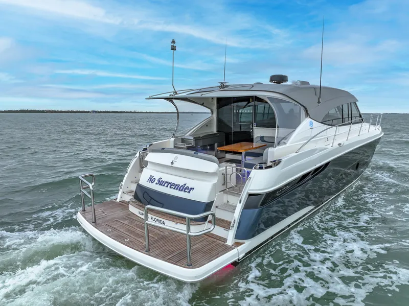 Slide: The Image of 2021 Riviera 5400 Sport Yacht cruising on open water. - 8