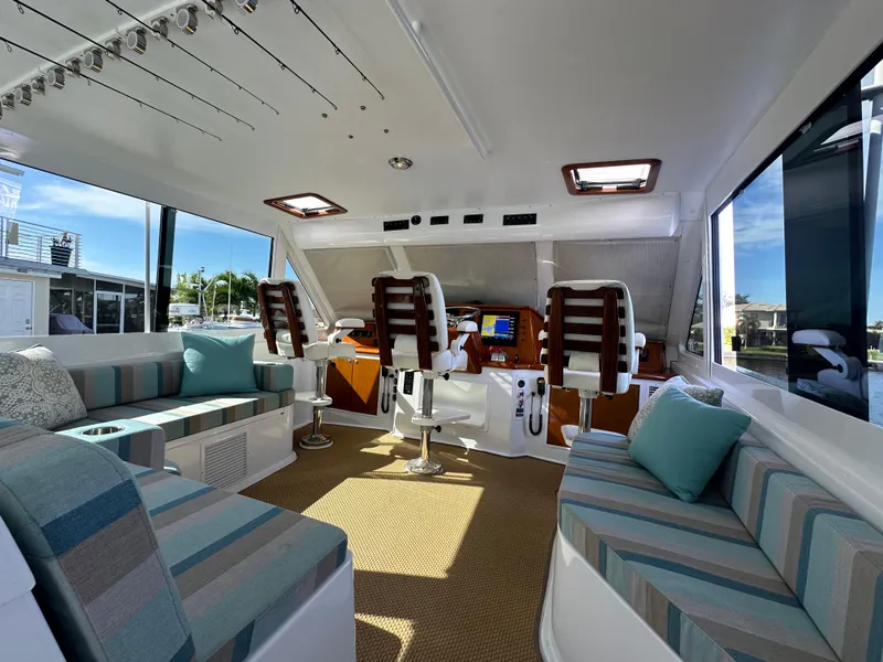 Slide: The Image of Luxurious interior of a 1999 Viking 60 Cockpit Sports Yacht with plush seating and helm. - 13