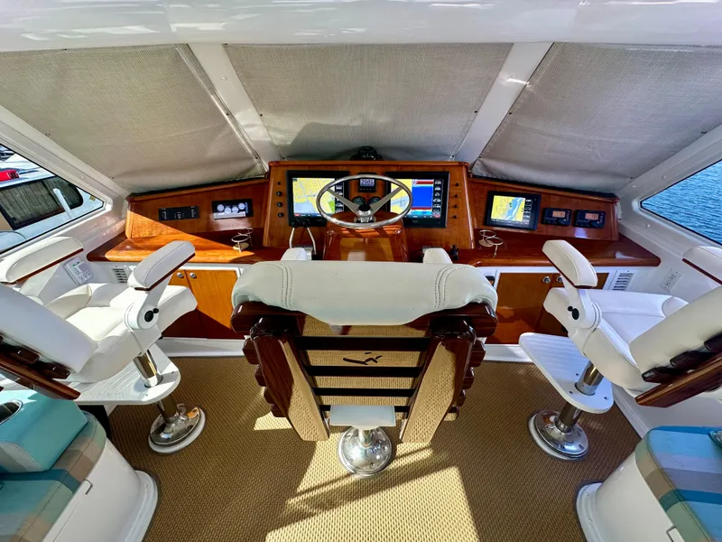 Slide: The Image of Cockpit of 1999 Viking 60 Sports Yacht with steering wheel and navigation screens. - 14