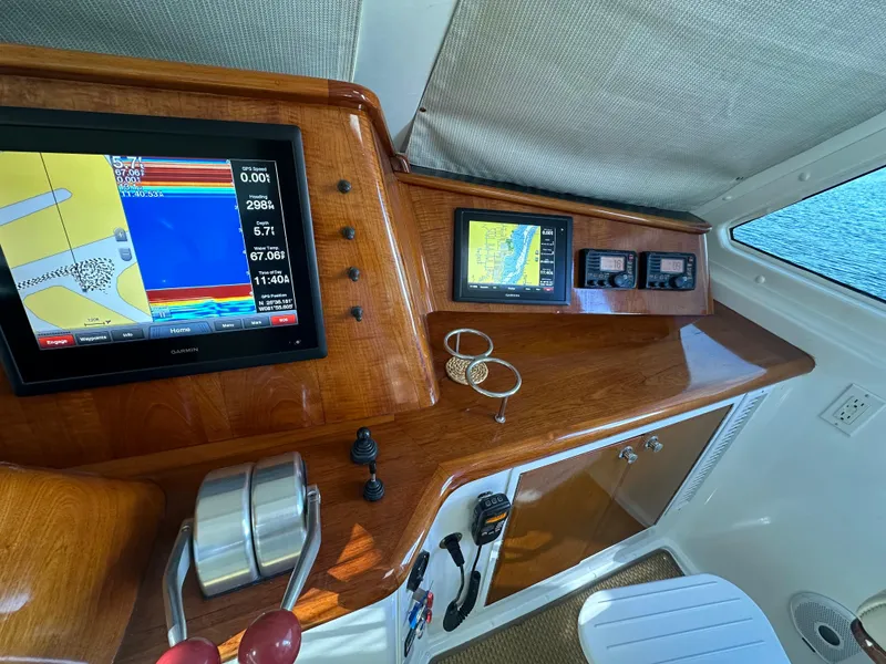 Slide: The Image of Control panel of a 1999 Viking 60 Cockpit Sports Yacht with navigation screens. - 17