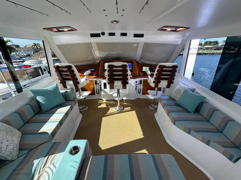 Slide: The Image of Luxurious 1999 Viking 60 Cockpit Sports Yacht interior with striped seating and helm station. - 19