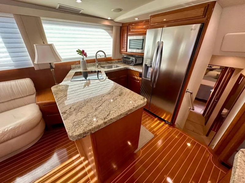 Slide: The Image of Luxurious kitchen interior of 1999 Viking 60 Cockpit Sports Yacht with granite countertops. - 21