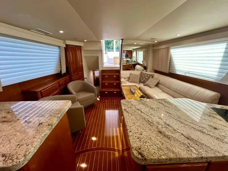 Slide: The Image of Luxurious interior of 1999 Viking 60 Cockpit Sports Yacht with granite countertops and plush seating. - 24