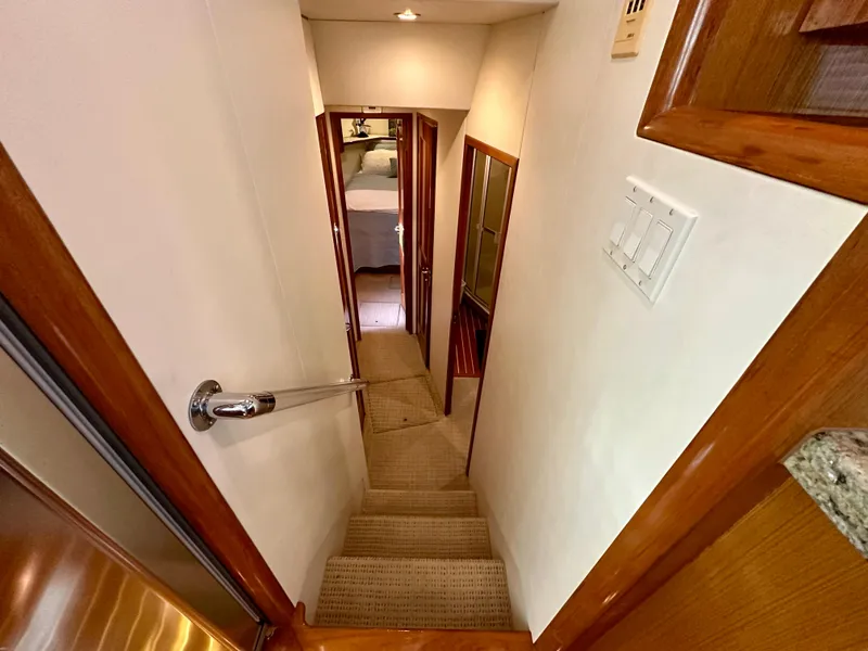 Slide: The Image of Stairway inside 1999 Viking 60 Cockpit Sports Yacht, leading to lower cabin area. - 25