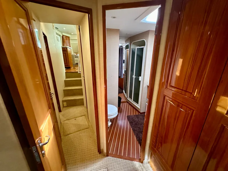 Slide: The Image of Interior of 1999 Viking 60 Cockpit Sports Yacht with wood paneling and carpeted stairs. - 32
