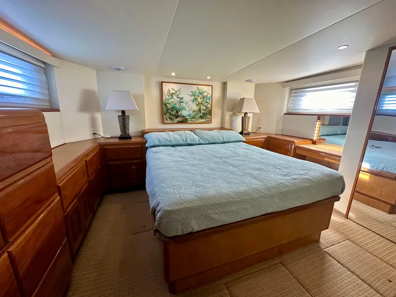 Slide: The Image of Luxurious bedroom in 1999 Viking 60 Cockpit Sports Yacht with elegant decor and ample natural light. - 37