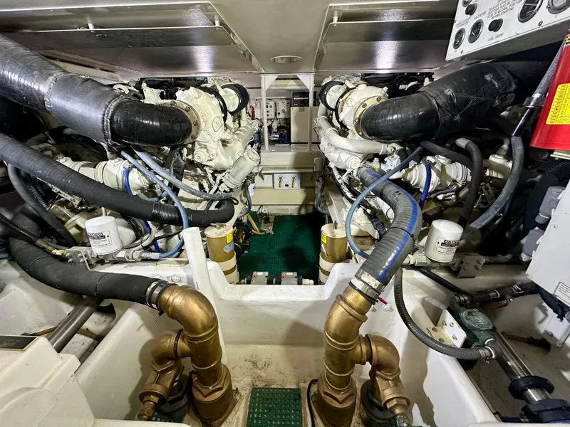 Slide: The Image of Engine room of 1999 Viking 60 Cockpit Sports Yacht with dual engines and complex piping. - 42