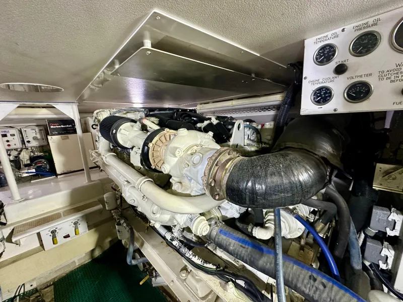 Slide: The Image of Engine room of 1999 Viking 60 Cockpit Sports Yacht, showcasing mechanical components and gauges. - 44