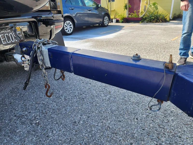 Slide: The Image of Trailer hitch of a 2005 Larson LXi 208 boat, parked in a lot. - 10