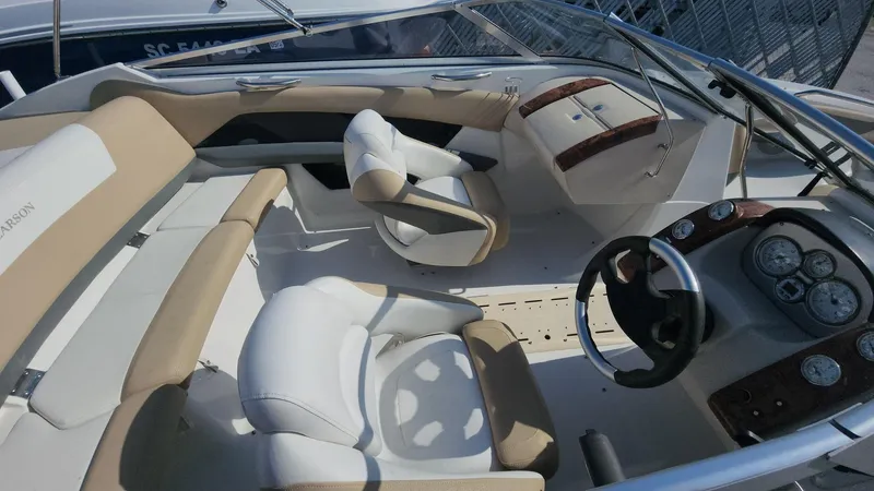 Slide: The Image of Interior of 2005 Larson LXi 208 boat with beige and white seating. - 2