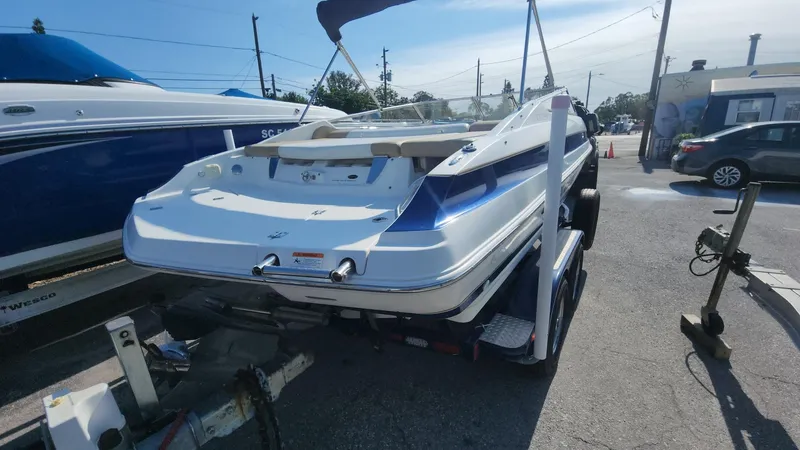 Slide: The Image of 2005 Larson LXi 208 boat on trailer in parking lot. - 23