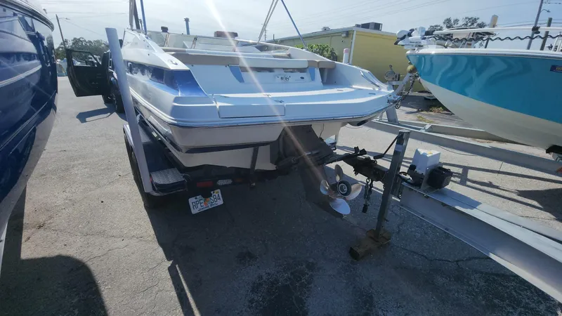 Slide: The Image of 2005 Larson LXi 208 boat on trailer, rear view, sunny day. - 25
