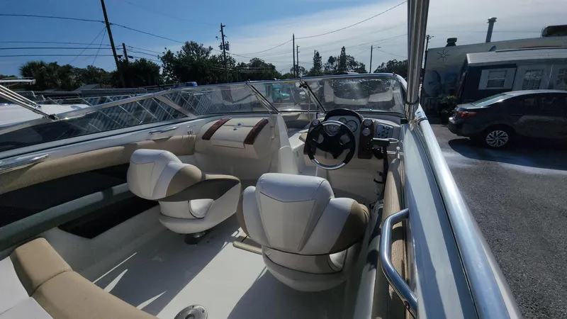 Slide: The Image of 2005 Larson LXi 208 boat interior with steering wheel and seating. - 26