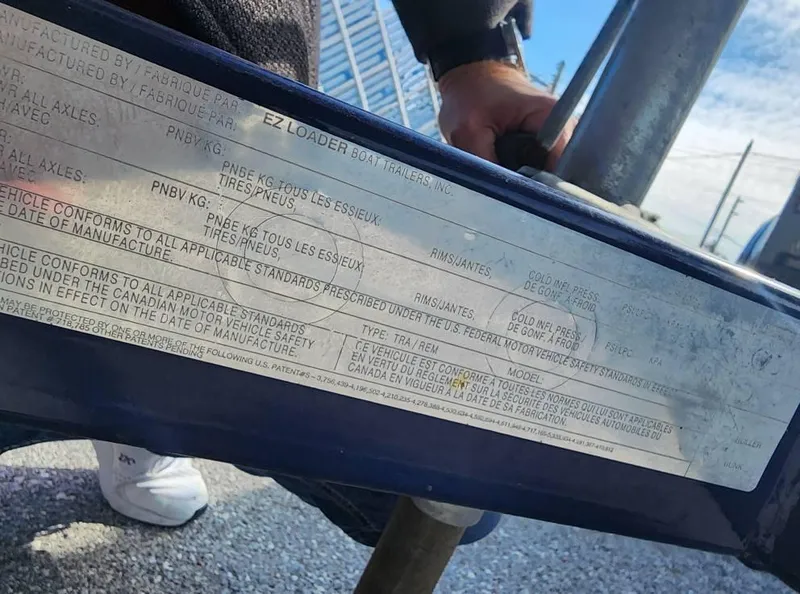 Slide: The Image of Close-up of a 2005 Larson LXi 208 boat trailer label with specifications. - 28