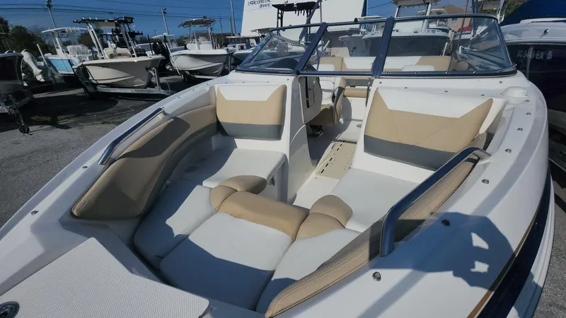 Slide: The Image of 2005 Larson LXi 208 boat with beige and white interior, docked outdoors. - 4