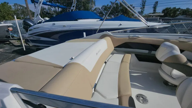 Slide: The Image of 2005 Larson LXi 208 boat interior with beige seating and sleek design. - 7