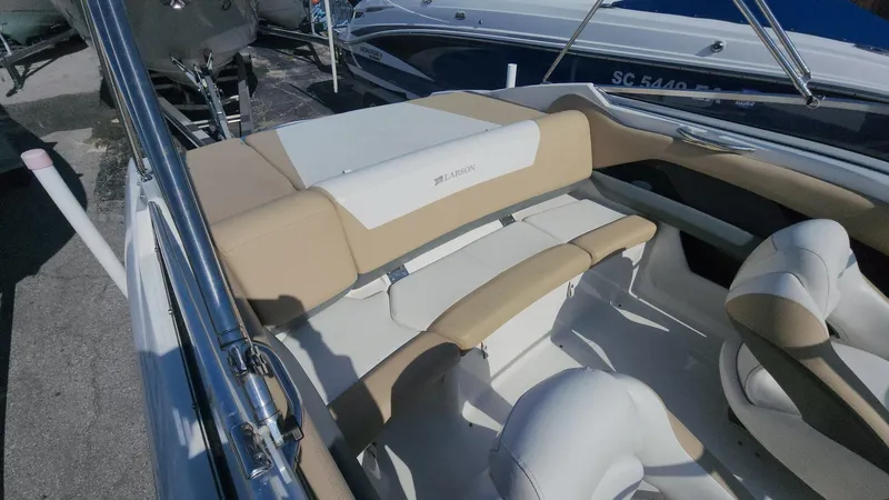 Slide: The Image of 2005 Larson LXi 208 boat interior with beige and white seating. - 8