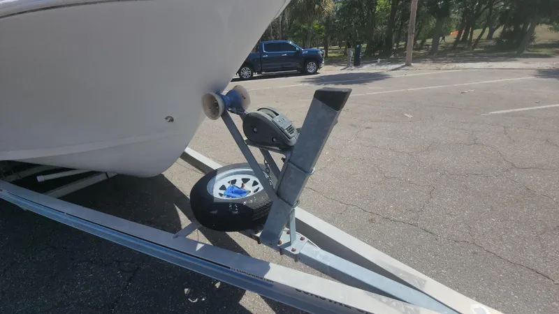 Slide: The Image of Trailer hitch of a 2003 Pro-Line 22 boat in a parking lot. - 10