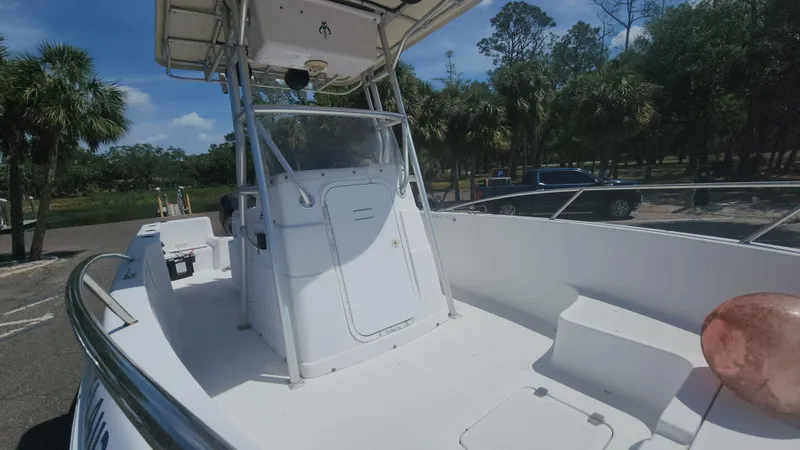 Slide: The Image of 2003 Pro-Line 22 boat with center console, parked outdoors under clear sky. - 12
