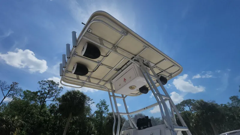 Slide: The Image of 2003 Pro-Line 22 boat T-top against a clear blue sky with trees in the background. - 16