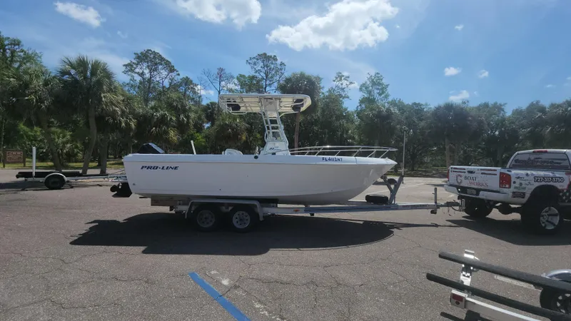 Slide: The Image of 2003 Pro-Line 22 boat on trailer in sunny parking lot. - 18