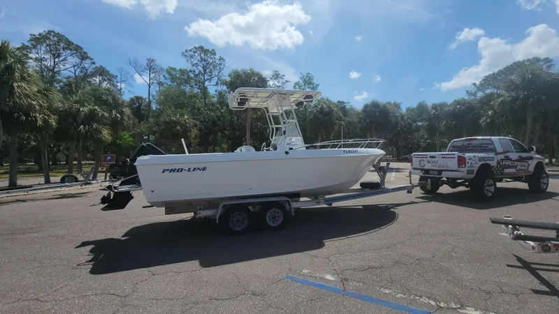 Slide: The Image of 2003 Pro-Line 22 boat on trailer, parked in sunny outdoor setting. - 19