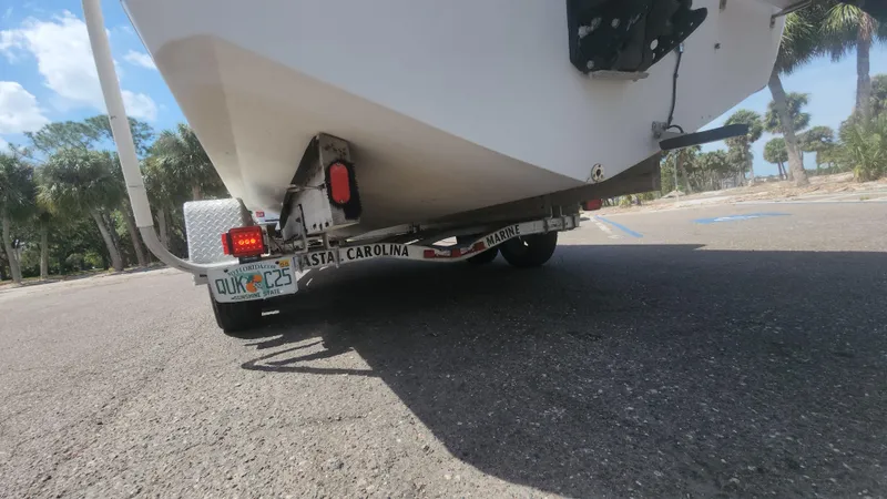 Slide: The Image of Trailer with 2003 Pro-Line 22 boat parked, showing rear view and license plate. - 21