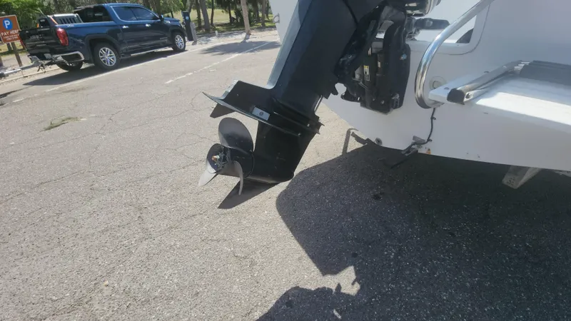 Slide: The Image of Outboard motor of a 2003 Pro-Line 22 boat in a parking area. - 24