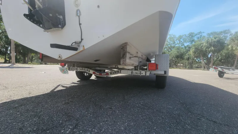 Slide: The Image of 2003 Pro-Line 22 boat on trailer, parked outdoors on sunny day. - 25