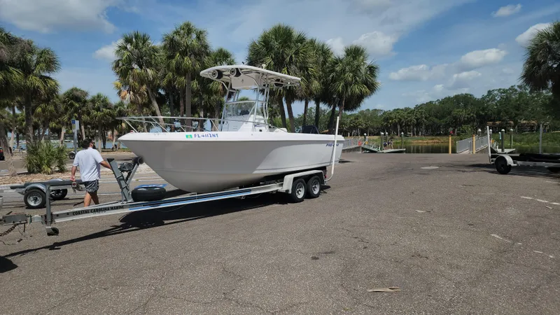 Slide: The Image of 2003 Pro-Line 22 boat on trailer at a sunny boat launch area. - 29
