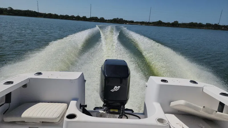 Slide: The Image of 2003 Pro-Line 22 boat cruising on a lake, leaving a wake behind. - 3