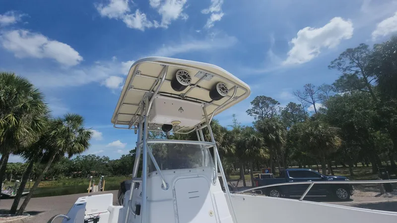 Slide: The Image of 2003 Pro-Line 22 boat with T-top, parked outdoors under a clear blue sky. - 36