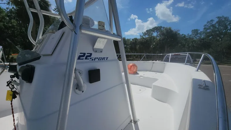 Slide: The Image of 2003 Pro-Line 22 Sport boat with white deck and railing under a blue sky. - 39