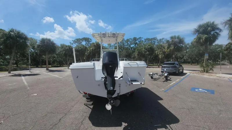 Slide: The Image of 2003 Pro-Line 22 boat with outboard motor in a sunny parking lot. - 51