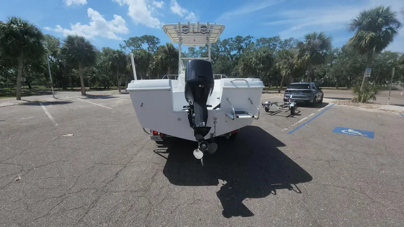 Slide: The Image of 2003 Pro-Line 22 boat with outboard motor in a sunny parking lot. - 52