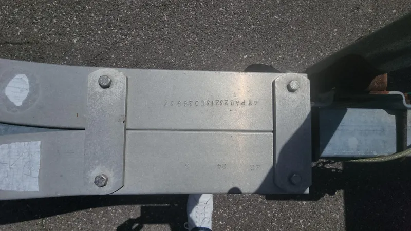 Slide: The Image of Close-up of a metal component on a 2003 Pro-Line 22 boat trailer. - 8