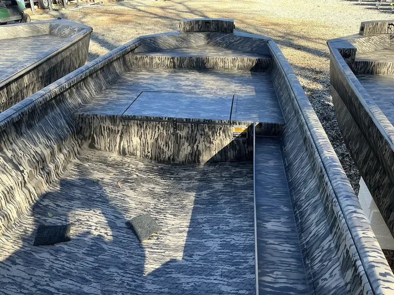 Slide: The Image of 2025 Reaper Boats 656 STEP TRANSOM MID DECK with camouflage design, empty interior view. - 4