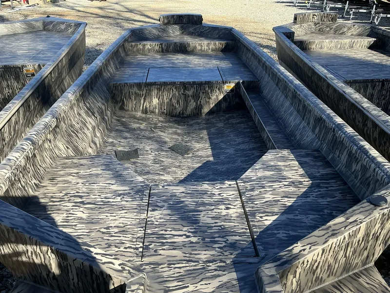 Slide: The Image of 2025 Reaper Boats 656 STEP TRANSOM MID DECK with camouflage design, displayed outdoors. - 6