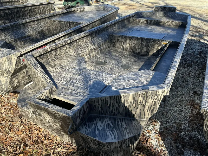 Slide: The Image of 2025 Reaper Boats 656 STEP TRANSOM MID DECK with camouflage design on gravel. - 8