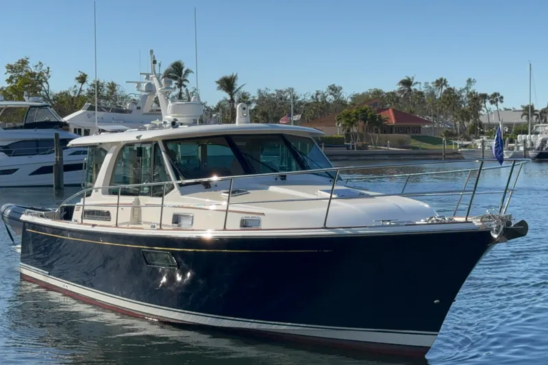 Slide: The Image of 2023 Sabre 43 Salon Express yacht docked in a marina. - 2