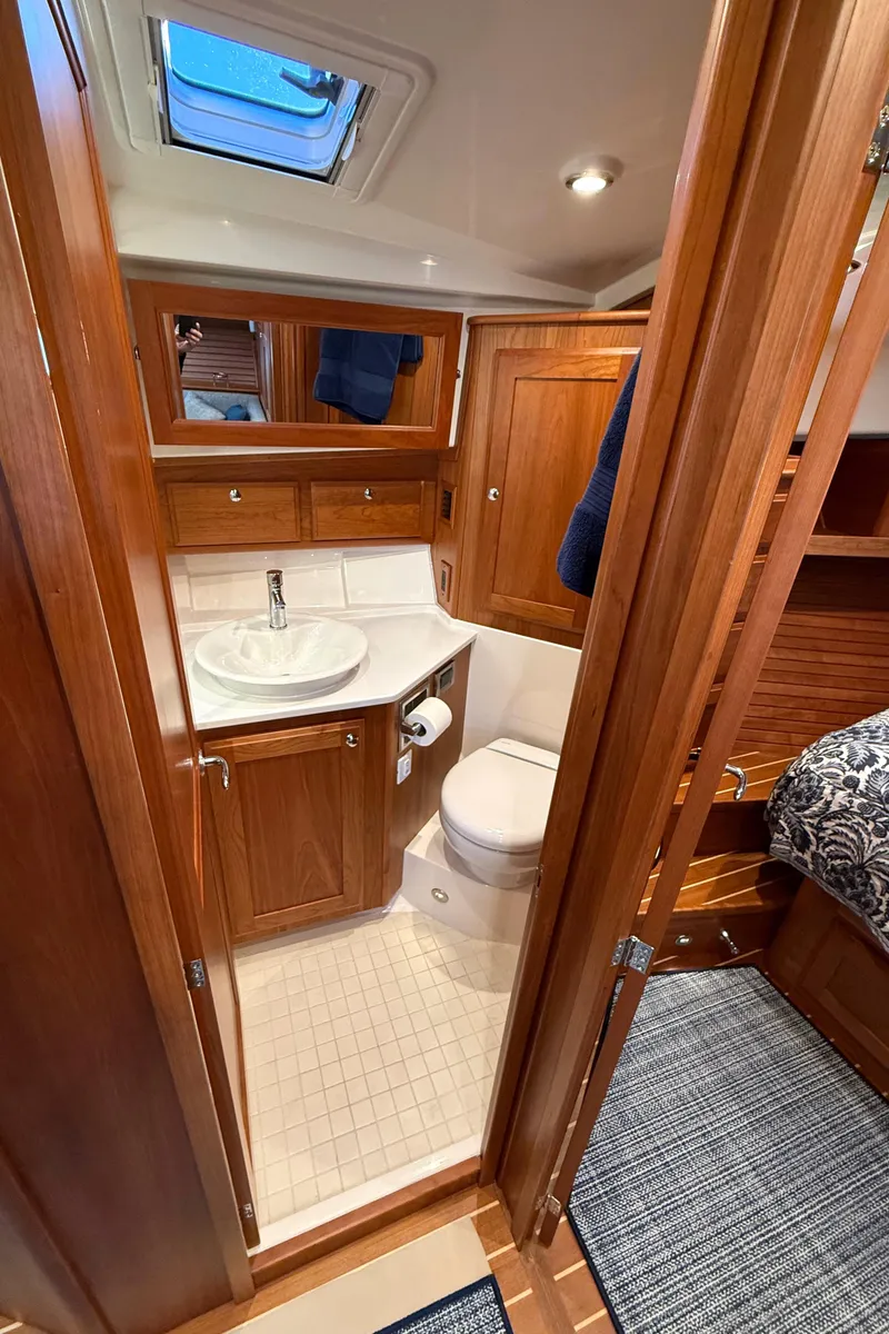 Slide: The Image of 2023 Sabre 43 Salon Express bathroom with wood cabinetry and skylight. - 34