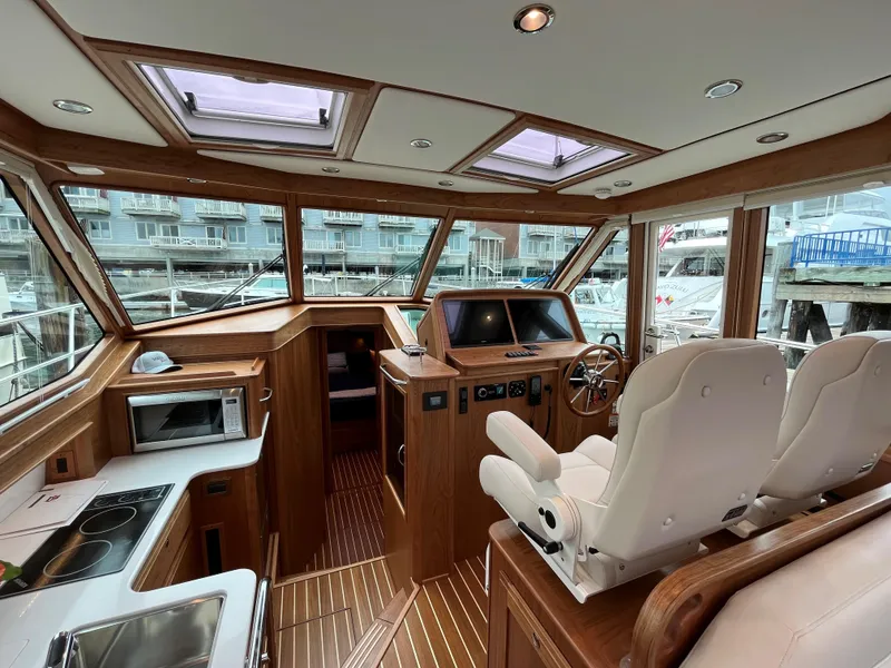 Slide: The Image of Interior of 2023 Sabre 43 Salon Express yacht with modern helm and kitchen area. - 37