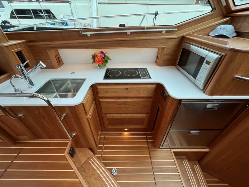 Slide: The Image of Luxurious kitchen in 2023 Sabre 43 Salon Express yacht with modern appliances and wood finish. - 38